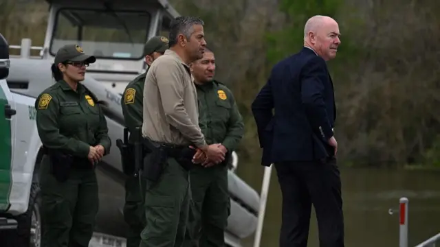 US Alejandro Mayorkas (R) speaks with border patrol agents as he visits the US-Mexico border with President Joe Biden in Brownsville, Texas, on February 29, 2024.