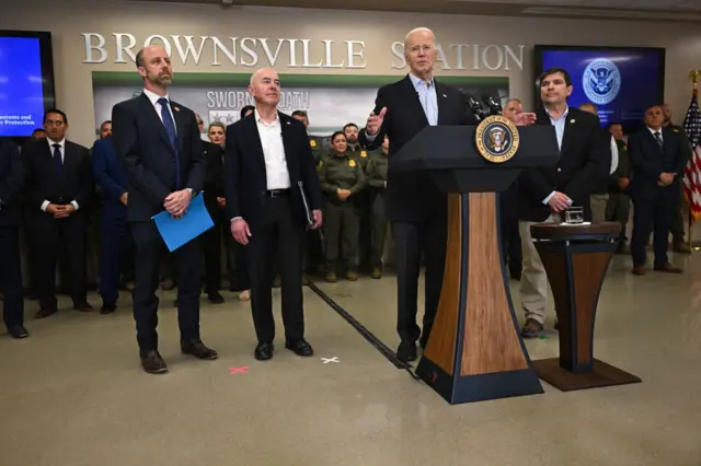 US President Joe Biden (C) flanked by Brownsville, Texas, Mayor John Cowen (L), Homeland Security Secretary Alejandro Mayorkas (2L) and Rep. Vicente Gonzalez (D-TX), speaks about immigration at the Brownsville Station during a visit to the US-Mexico border in Brownsville, Texas, on February 29, 2024