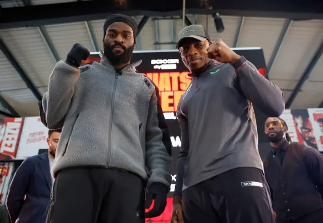 Joshua Buatsi (left) and Dan Azeez (right) stand side by side and hold a fist up