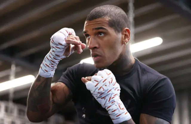 Conor Benn holds his hands up