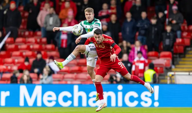 Celtic's Maik Nawrocki and Aberdeen's Bojan Miovski challenge for an aerial ball