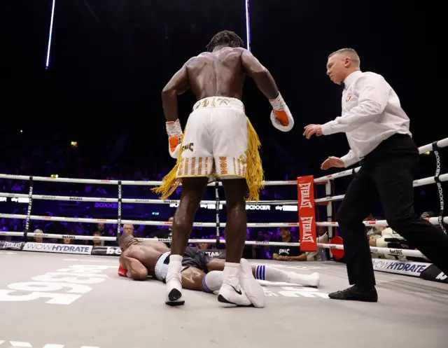 Dan Azeez lies on the floor with Joshua Buatsi stood over him