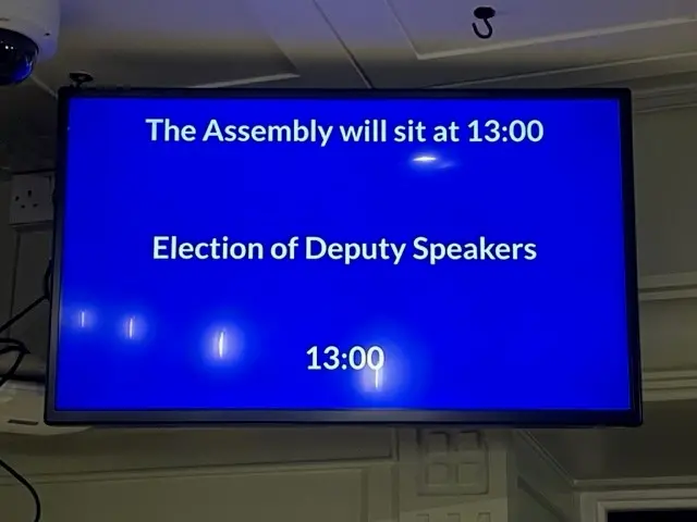 Screen with text reading "The Assembly will sit at 13:00. Election of Deputy Speakers 13:00