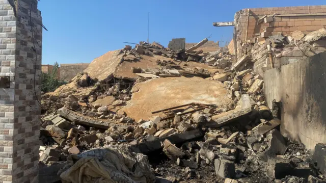 A destroyed building is pictured at the site of a US strike in al-Qaim, Iraq