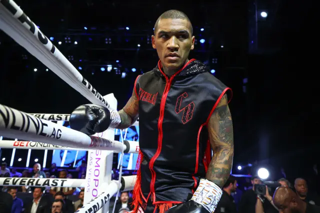 Conor Benn enters the ring dressed in red and black