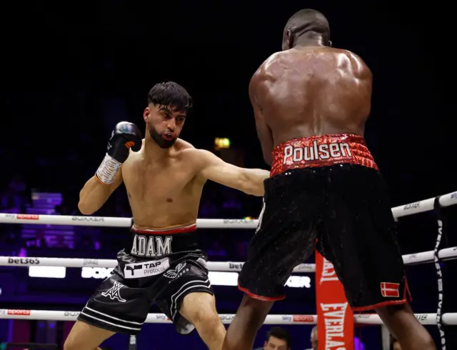 Adam Azim (left) lands a punch on Enock Poulsen (right)