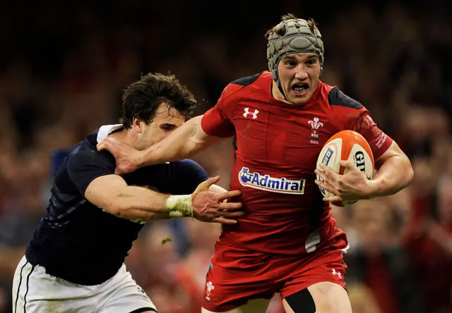 Jonathan Davies fends off Scotland player