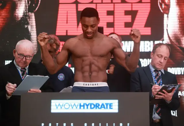 Dan Azeez holds up his fists as he weighs-in