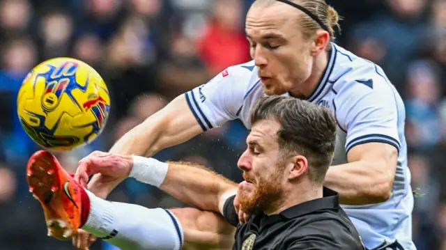 Bolton and Barnsley players challenge for the ball