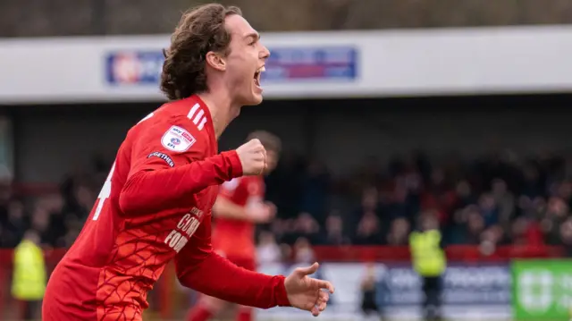 Harry Forster celebrates a goal for Crawley