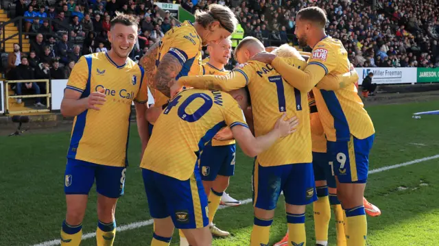 Mansfield celebrate a goal at Notts County