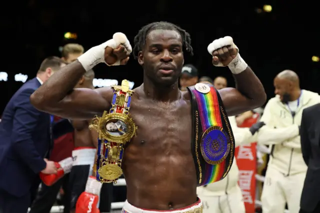 Joshua Buatsi holds up his titles