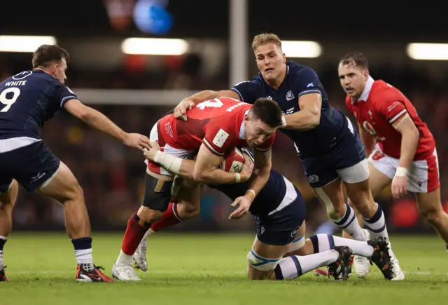 Scotland's Duhan van der Merwe tackles Josh Adams of Wales