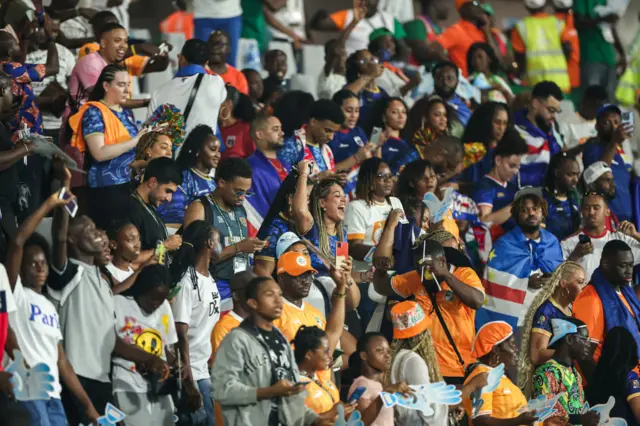 Supporters cheer for both teams