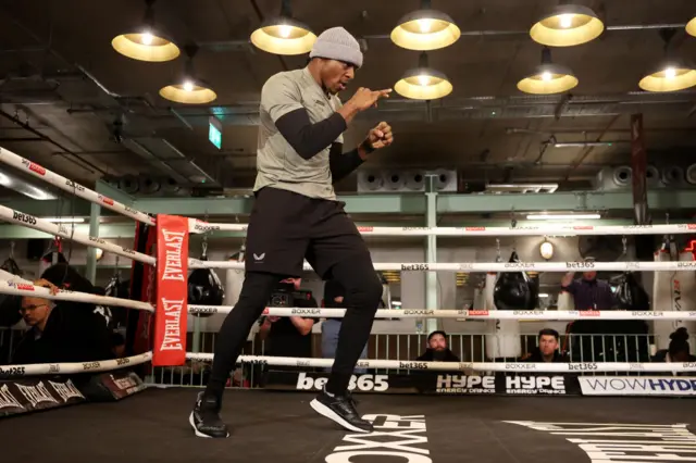 Dan Azeez stands in a boxing ring