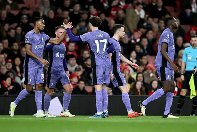 The Liverpool players celebrate an own goal