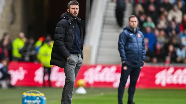 Michael Carrick and Michael Beale on the touchline