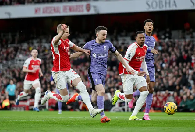 Diogo Jota of Liverpool runs with the ball whilst under pressure from Oleksandr Zinchenko