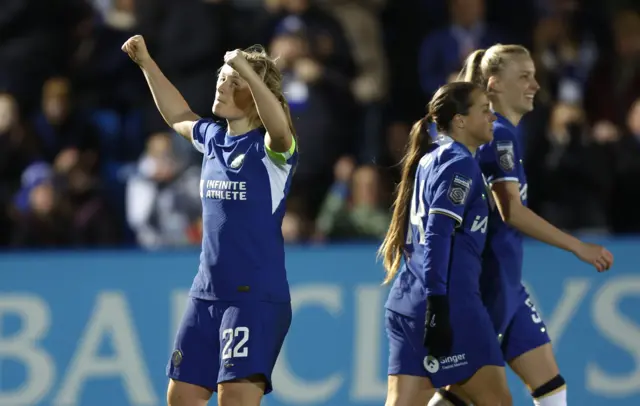 Ein Cuthbert pumps her fists to the fans after scoring Chelsea's third goal.