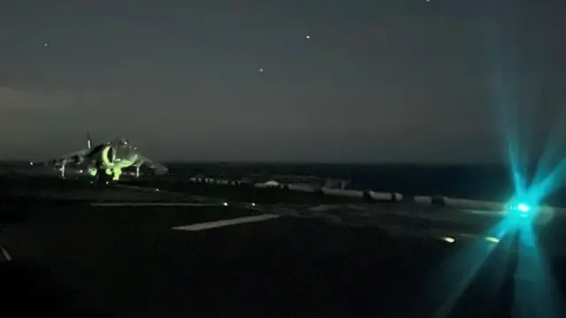 A jet taking off from the USS Bataan