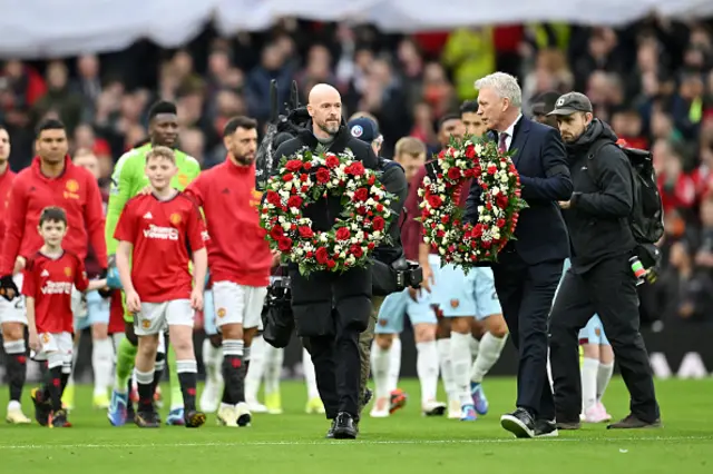 Erik ten Hag, Manager of Manchester United, and David Moyes, Manager of West Ham United, carry wreaths