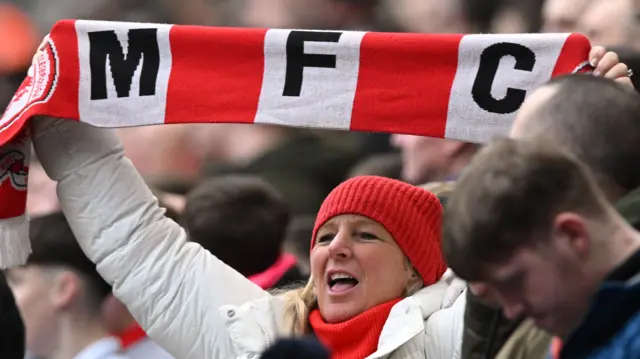 Middlesbrough fan holds up scarf