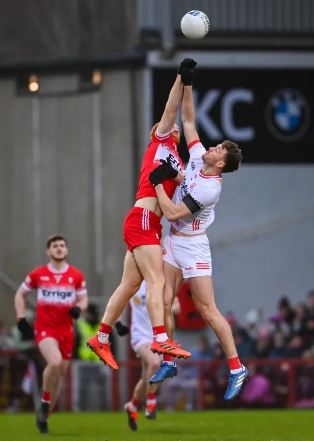 Conor Glass of Derry in action against Brian Kennedy of Tyrone