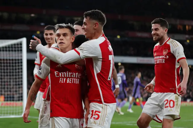 Leandro Trossard (C) celebrates with teammates