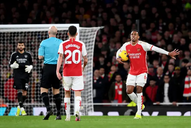 Gabriel of Arsenal reacts towards Referee Anthony Taylor