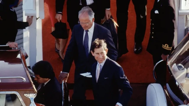 The two men walk a red carpet