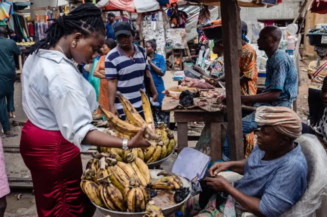 A shopper looks at food for sale in Yaba market, Lagos, in 2023.