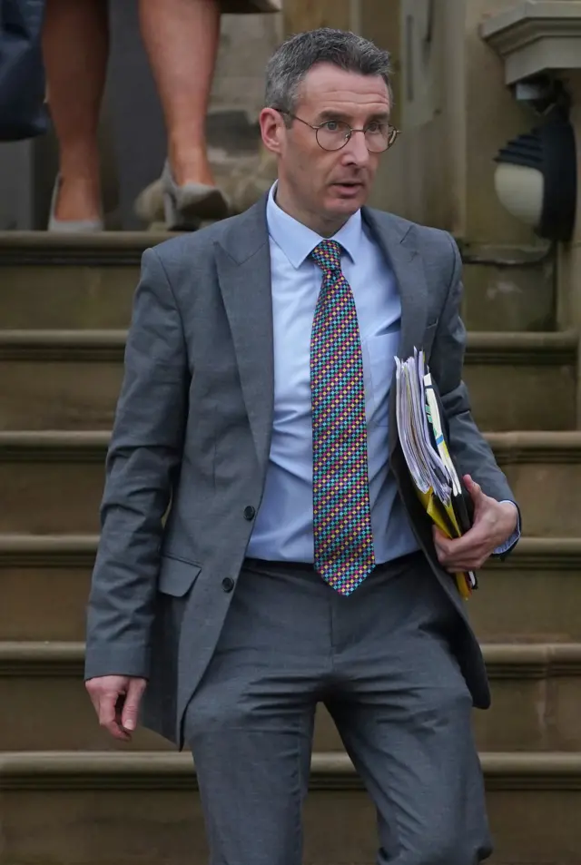 Andrew Muir walks down steps of Stormont Castle