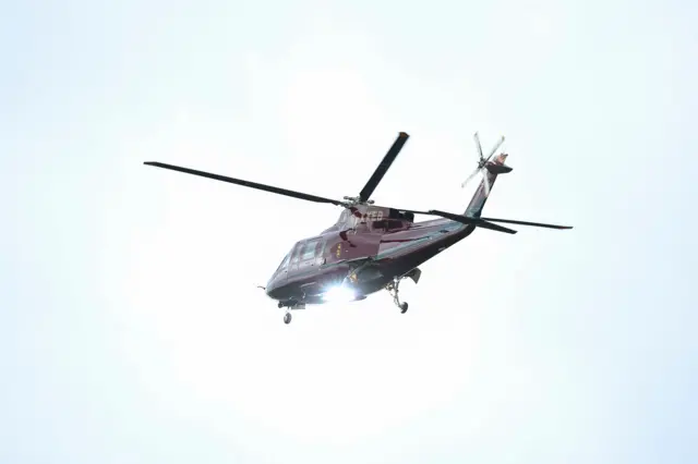 The Royal Household helicopter flies over central London to land at Buckingham Palace