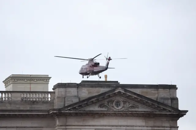 A helicopter lands at Buckingham Palace