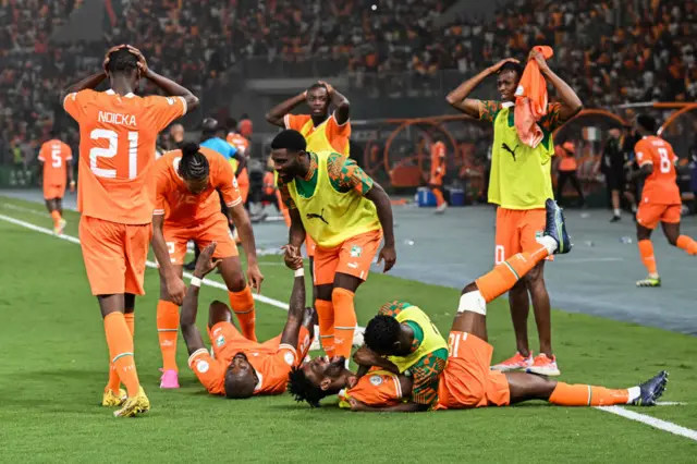 Ivory Coast players celebrate their winning goal v Mali with looks of disbelief.