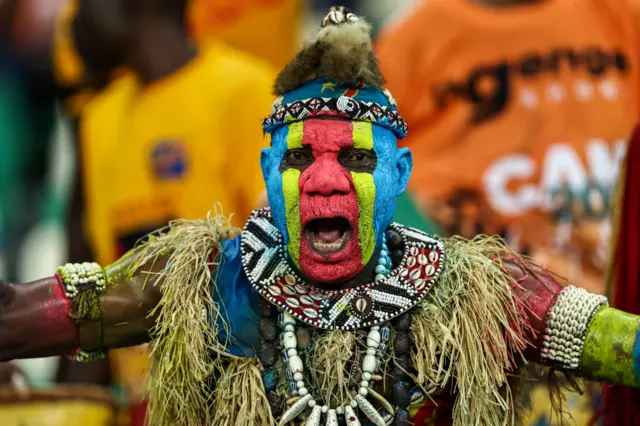 A DR COngo gan in face paint in the stands.