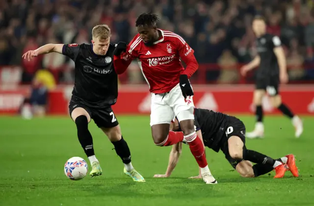 Ross McCrorie in action with Nottingham Forest's Divock Origi