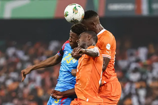 A DRC attacker is crowded out in an aerial duel in the box.