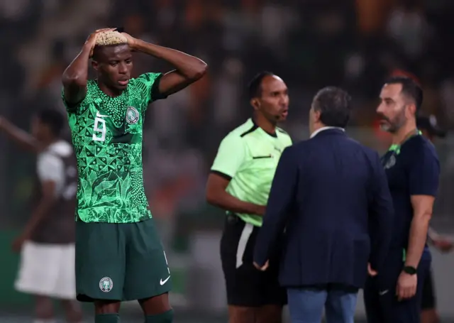 Osimhen holds his head in disbelief.