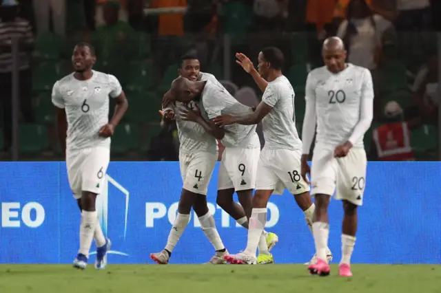 South Africa players celebrate with Mokoena after his late equaliser.