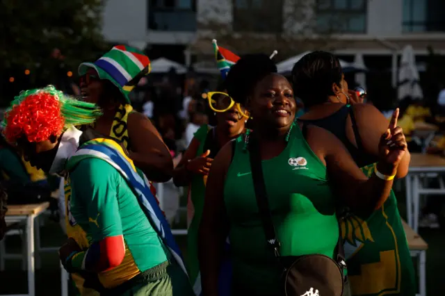 South Africa fans dance outside the stadium.