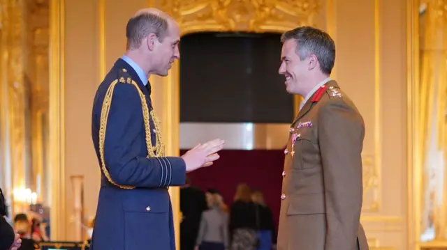 Brigadier Tobias Lambert is made an Officer of the Order of the British Empire by the Prince of Wales at Windsor Castle.