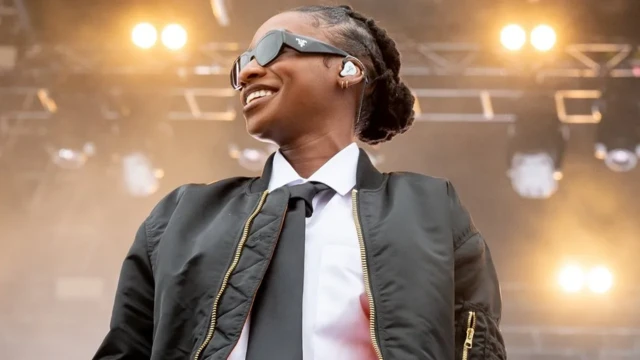 Little Simz in sunglasses and a leather jacket on stage