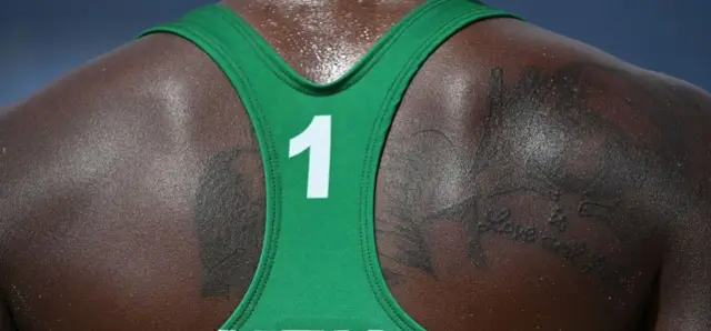 A tattoo on the back of Kenya's Gaudencia Makokha is seen in their women's preliminary beach volleyball pool D match between the USA and Kenya during the Tokyo 2020 Olympic Games at Shiokaze Park in Tokyo on July 29, 2021.