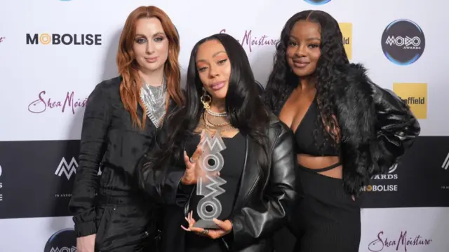 The three Sugababes pose with their award