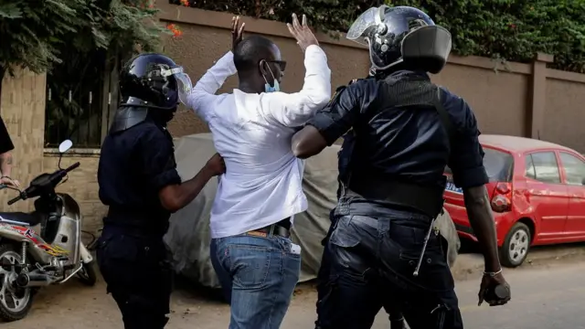 Riot police officers detain a protester who was gathering with others to protest the postponement of the February 25 presidential election, near Senegal's National Assembly in Dakar, Senegal February 5, 2024.