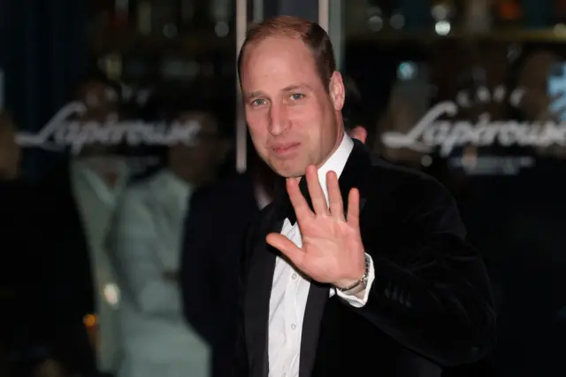 Prince William waves as he arrives for the London Air Ambulance charity gala dinner in London