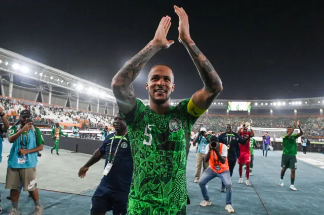 Troost-Ekong applauds the fans from the surroundings of the pitch.