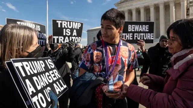 Gabriel Chambers (C), a supporter of former US President Donald Trump, speaks anti-Trump demonstrators protesting outside the US Supreme Court in Washington, DC, on February 8, 2024. The Court began a high-stakes hearing on whether Trump is ineligible to appear on the Republican presidential primary ballot in the state of Colorado because he engaged in an insurrection, the January 6, 2021, assault on the US Capitol by his supporters.