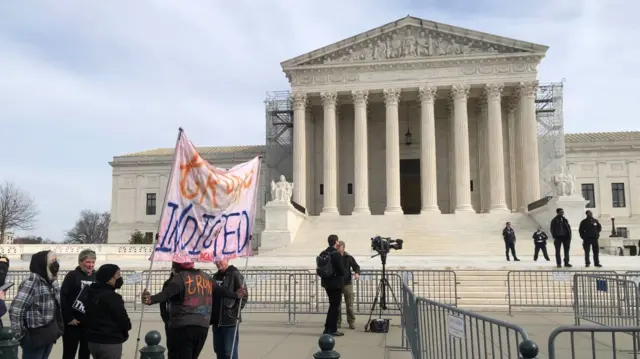 A small group of protesters outside the Supreme Court in Washington DC